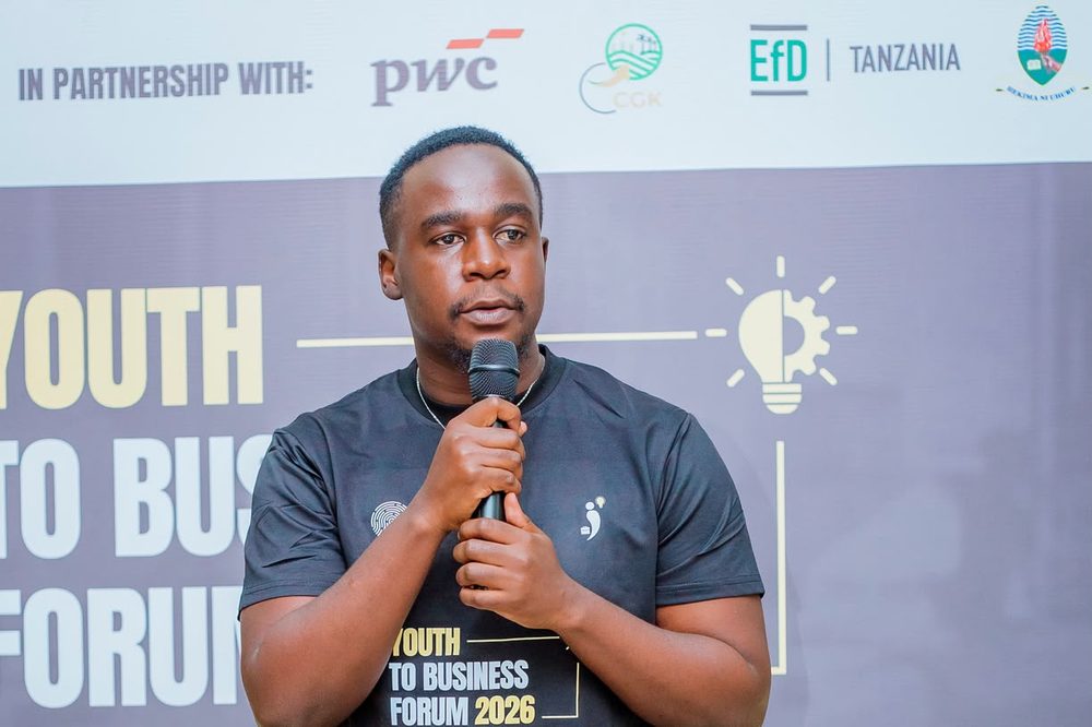 Valence Mwigani speaking with a microphone at the Youth to Business Forum 2026